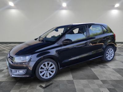a black volkswagen b - cross parked on a checkered floor
