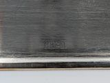 an image of a silver plate with the word metal on it