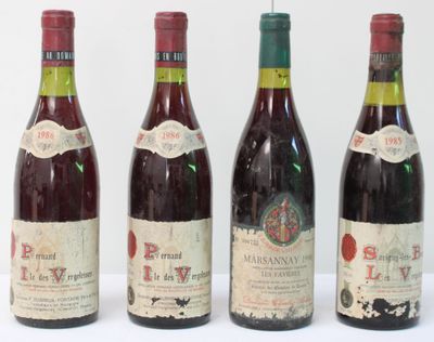 four bottles of wine are lined up on a white surface