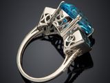 a close up view of a ring with a blue topaz stone