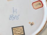 a white plate with a blue and yellow design on it