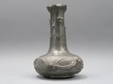un vase en argent posé sur une table