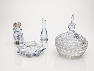three glass objects sitting on a white surface