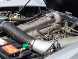 a close up of a car ' s engine with its hood open