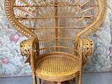 a wicker chair that is sitting in front of a wall