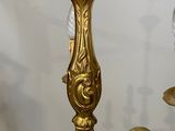 a gold chandelier with a glass ball on top of it