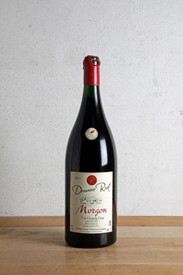 a bottle of wine sitting on a wooden table