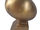 a gold duck statue on a stand on a white background