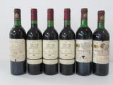 six bottles of wine are lined up in a row on a white surface