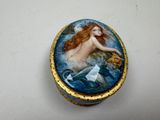 a small box with a picture of a mermaid on it