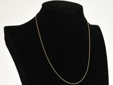 a black mannequin with a gold chain on it