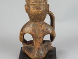 an old wooden figurine of a man with a hat on his head