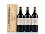 three bottles of red wine in a wooden box