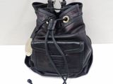 black leather handbag with a strap and a tag on it