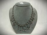 silver necklace with crystal drops on a mannequin display