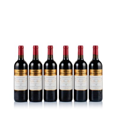 six bottles of red wine lined up in a row