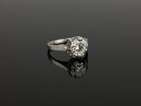 a close up of a diamond ring on a black surface