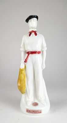 a figurine of a man with a yellow bag in his hand