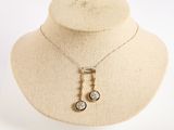 silver and black druzy necklace on a mannequin neck