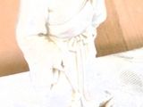 a statue of a man sitting on a table with a pink piece of paper