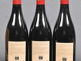 three bottles of wine sitting on top of a table next to each other