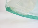a close up of a glass container with a piece of ice in it