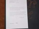 the book is open on a table with a notepad and pen