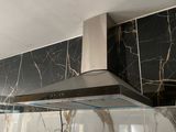 a picture of a kitchen with a black and white marble backsplash