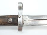 a close up of a knife on a white surface