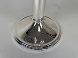 a silver candle that is sitting on a white table