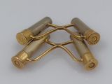 three brass plated rollers on a white surface with a white background