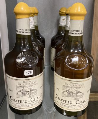 three bottles of chateau chambo are sitting on a glass shelf