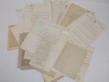a lot of old papers on a white table