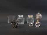 five different glass vases on a table with a black background