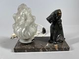 a statue of a woman sitting next to a lamp