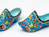 une paire de sabots bleus ornés de motifs floraux colorés