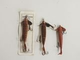 three different types of fishing lures on a white surface