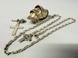 a cross, a bell, and a chain on a table