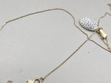 a gold necklace with a heart and key on a chain