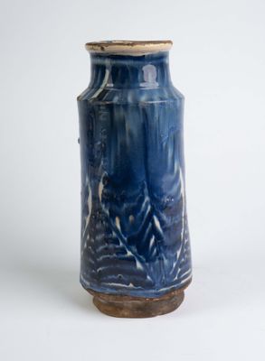 a blue vase that is sitting on a white surface