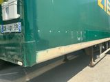 a green truck that is parked on the side of the road
