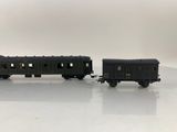 two toy trains sitting on top of a white surface