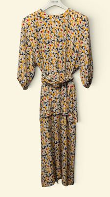 a dress hanging on a hanger against a white wall