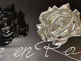 three black and silver roses sitting on a black surface