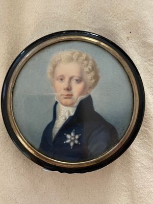 portrait of a young man in a blue coat and white shirt