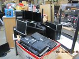 a pile of electronics on a table in a store