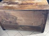 a wooden box sitting on a tiled floor in a room