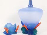 a blue vase and a blue and orange vase on a white background