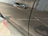 a close up of a car door handle on the side of the road