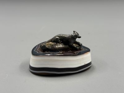 a close up of a figurine of a dog laying on a book